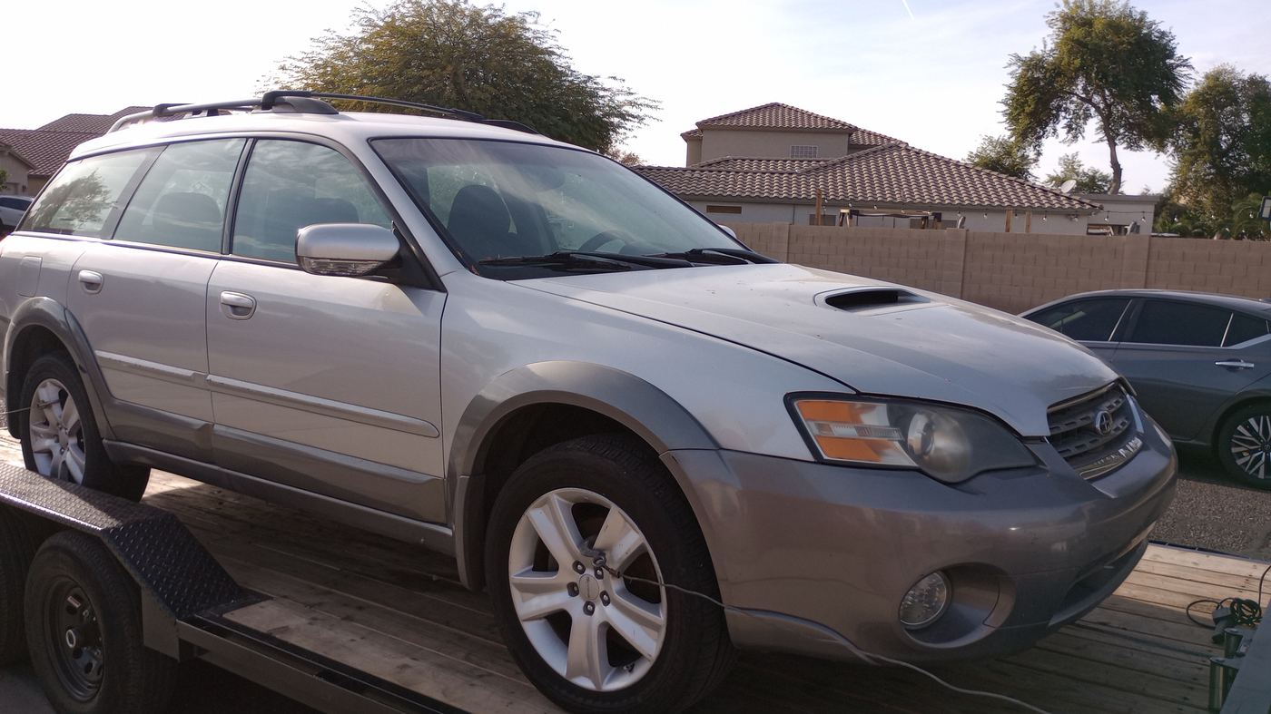We Buy Car Laveen Village tow truck picking up a car in a Laveen neighborhood