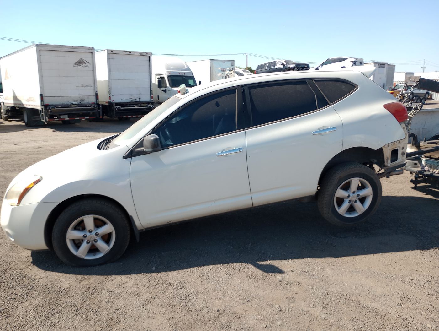 White Nissan Rogue among cars and trucks in the Laveen Village yard